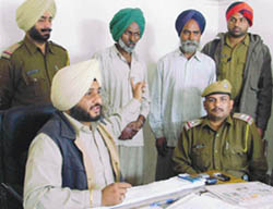 The police with the accused who were caught in a recruitment scam.