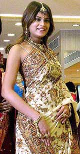 A model moves on the ramp at a fashion show during the inauguration of a wedding shopping mall in Kolkata