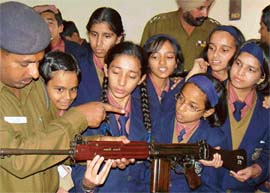 A policeman explains the mechanism of a gun to students of Ryan International School, Sector 49,  during their visit to the Sector 34 police station in Chandigarh on Thursday.