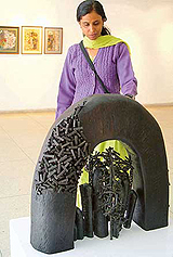 Artist Gurpreet Kaur with one of her sculptures on display at the Sculpture and Drawings Exhibition being held at Alliance Francaise, Sector 36, Chandigarh, on Friday.