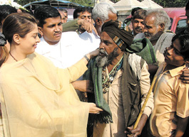 Actress Nagma distributing blankets to the poor on the occasion of International Human Rights Day during a function of All India Muslim Yuva Ekta Committee at Hanuman Temple, Connaught Place, in the Capital.