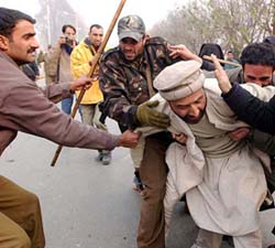 The police in action against Hurriyat Conference activists who hold a demonstration to protest against the alleged human rights violations, on the occasion of Human Rights Day, in Srinagar on Friday.