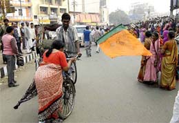 Protesting against atrocities on women in Bihar, a BJP worker tries to stop a rickshaw at Dak Bunglow crossing in Patna on Friday. 