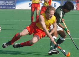 Spains David Alegre tries to snatch the ball from Pakistani captain Waseem Ahmed during their Champions Trophy hockey match at Lahore on Friday.