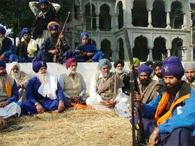 Col G.S. Sandhu (retd), chairman of the Majha Ex-servicemen Human Rights Front (fourth from left), with armed Nihangs at Gurdwara Bhai Taru Singh in Poohla village, Tarn Taran