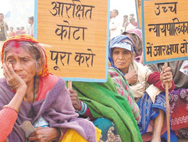 Activists under the banner of All India Confederation of SC/ST Organisations at a rally in the Capital on Sunday.