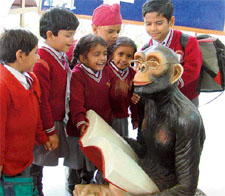 Look, he is studying too! Schoolchildren looking at the statue of a monkey put up in a school seem to be telling one another in Ludhiana 
