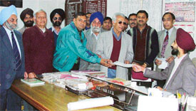 Residents of the Model Town Extension area submit a memorandum to the Chairman of the Improvement Trust, Mr Ashok Singh Garcha, in Ludhiana on Monday