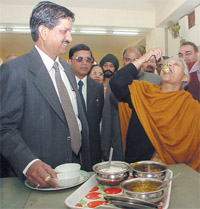 Chief Minister Sheila Dikshit with R.P. Singh, DG of Prisons, Delhi, tasting the food prepared by the inmates of Rohini District Jail in the Capital on Tuesday. 