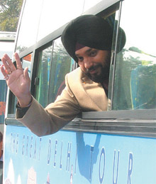 Destination Delhi: Delhi Tourism Minister Arvinder Singh Lovely waving after inaugurating the hop on, hop off bus service at Connaught Place in the Capital. 
