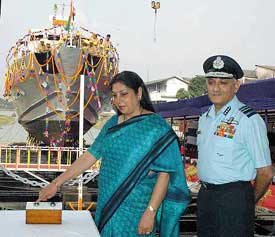Anita Bhavnani, wife of Air Marshal Ajit Bhavnani, presses the button to launch fast-attack vessel INS Bitra at Garden Reach shipyards in Kolkata on Tuesday afternoon.