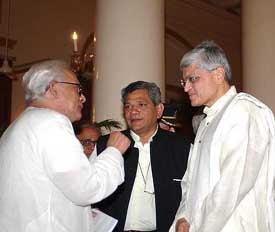 The new West Bengal Governor, Mr Gopal Krishna Gandhi, has a word with state Chief Minister Buddhadeb Bhattacharjee and senior CPM leader Sitaram Yechury after the swearing-in ceremony at Raj Bhavan in Kolkata on Tuesday. 