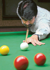 Sandeep Duggal aims at a ball at the 20th Chandigarh Snooker and Billiards meet in Sector 22, Chandigarh, on Wednesday.