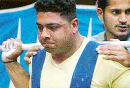 A participant tries his hand at the power lifting squat event in the 90 kg category of the Inter-College Weightlifting Meet at Panjab University in Chandigarh on Wednesday. 