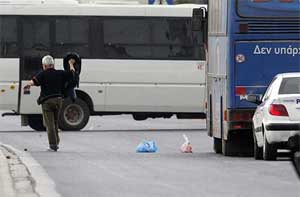 A hostage raises his arms after he is released from a hijacked bus