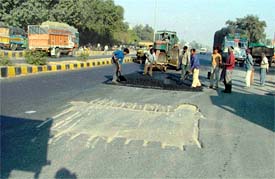 Workers repair patches on the Ferozepore road in Ludhiana