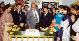 Mr Amrit Lal Aggarwal, Chairman of the local chapter of Aakash Institute, cuts a cake to mark the first anniversary of the institute in Ludhiana