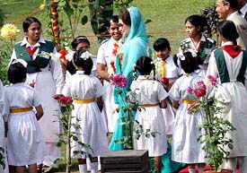 Bangladeshi school childred greet Prime Minister Khaleda Zia as she walks on the dais during a Victory Day function in Dhaka on Thursday. 