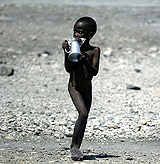 A Haitian boy walks nude in Cite Soleil district of Port-au-Prince