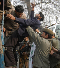 Police personnel prevent supporters of the Jammu Kashmir Peoples Freedom League from protesting against human rights violations at Srinagar on Friday. 