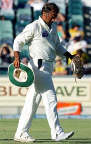 Shoaib Akhtar hobbles off the ground due to an ankle injury on the second day of the first Test against Australia in Perth