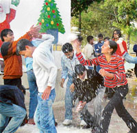 Snowfall near Chandigarh!: Revellers play as snowflakes drop during an artificial snowfall created at the Funcity amusement park, near Chandigarh, on Saturday. 
