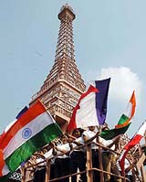 People waving the Indian National Flag from a replica of the Eiffel Tower