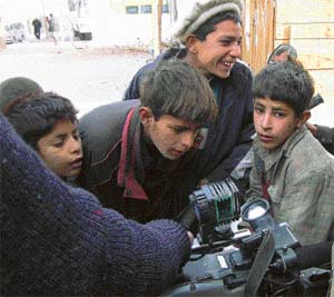 "Its a computer," says one of the boys as they crowd around and take a close look at a TV camera