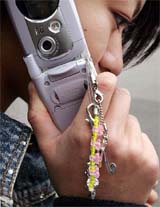 Fashion accessories dangle from a Japanese high school students mobile phone in Tokyo on Sunday. For the average Japanese teenager, a cell phone is a must-have item, used for email, taking photos and keeping track of dates, in addition to the simple phone call. 
