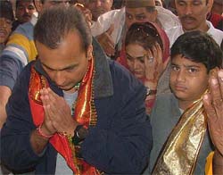 Reliance Industries Vice-Chairman Anil Ambani with his wife Tina and son pray at a Goverdhan temple in Mathura on Sunday.  