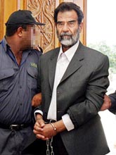 Deposed Iraqi President Saddam Hussein is led in shackles