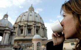 A tourist enjoys a cappuccino outside the rooftop coffee bar of Saint Peters Basilica at the Vatican on Monday. 