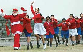 Train Ride with Santa Claus: Schoolchildren line up in a row to form a train during Christmas celebrations at Carmel Convent School in Sector 9, Chandigarh, on Monday. 