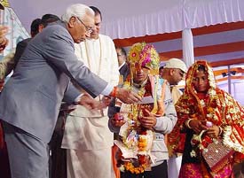 Haryana Governor A. R. Kidwai blessing a newly wed couple at a mass marriage function organised by Sri Jai Ram Vidyapeeth