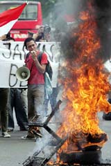 Indonesian university students burn tyres during a protest against the recent fuel hikes in Jakarta on Monday.