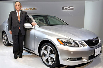 Toyota Motor Corp President Fujio Cho stands next to the companys Lexus.