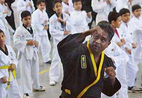 Marshall Pereira from the USA gives tips to students during a choi kwon do martial art training camp at the skating rink, Sector 10, Chandigarh