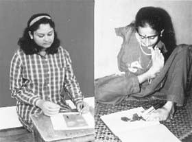 Swapna uses her toes to paint Christmas cards while Mary draws with her mechanical hand