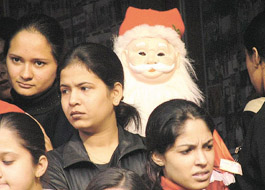 Girls with Santa Claus in a market in the Capital.