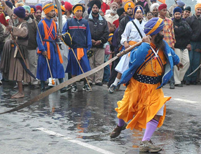 A Nihang performs during a nagar kirtan organise to observe the 300th year of the martyrdom of Sahibzadas of Guru Gobind Singh in Banur on Wednesday. Due to the nagar kirtan, vehicular traffic on the Zirakpur-Patiala highway remain disrupted for over six hours.