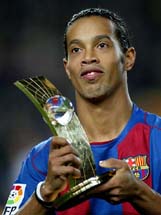 Soccer star Ronaldinho holds his trophy after he won FIFAs World Player of the Year Award in Zurich.