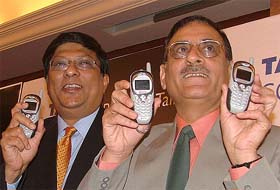 Tata Teleservices Ltd. President Amit Bose and Tata Teleservices Chief Operating Officer for Delhi Circle, Dr Naresh Malhan, pose with Push to Talk (PTT) mobile phones in New Delhi