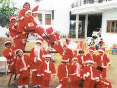 Children of Small Wonders Nursery School, dress up as Santa Claus to celebrate Christmas in Ludhiana on Thursday.