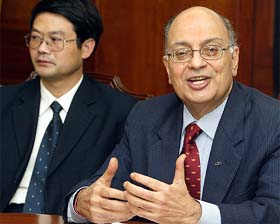 Mahindra & Mahindra Ltd companys Vice President Anjanikumar Choudhari speaks as the chairman of Jiangling Tractor company, Chou Ming, looks on during a news conference in Mumbai