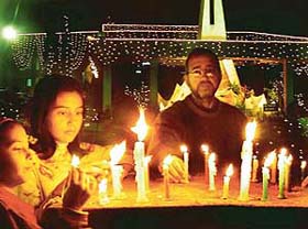 Candles of faith: Christians light candles at the Catholic Church in Sector 19, Chandigarh, on the eve of Christmas