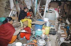 Members of a family eat food in the ruins of their house after MC, Shimla, carried out a demolition drive at Lal Bagh, near Tara Hall