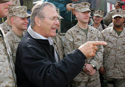 US Secretary of Defence Donald Rumsfeld (centre) talks to US Marines in a camp near the Iraqi town of Falluja, 50 km west of Baghdad, on Friday. 
