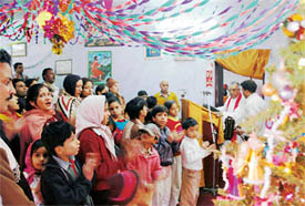 Rev Suresh conducts a prayer meeting at United Church of Northern India on the Christmas Day in Ludhiana