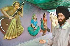 Sculptor Baljit Singh makes a point about his rare creation in sand at Dev Samaj College of Education for Girls, Sector 36