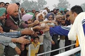 A Pakistani player and people reach out to each other during the India-Pakistan Punjab Games in Patiala